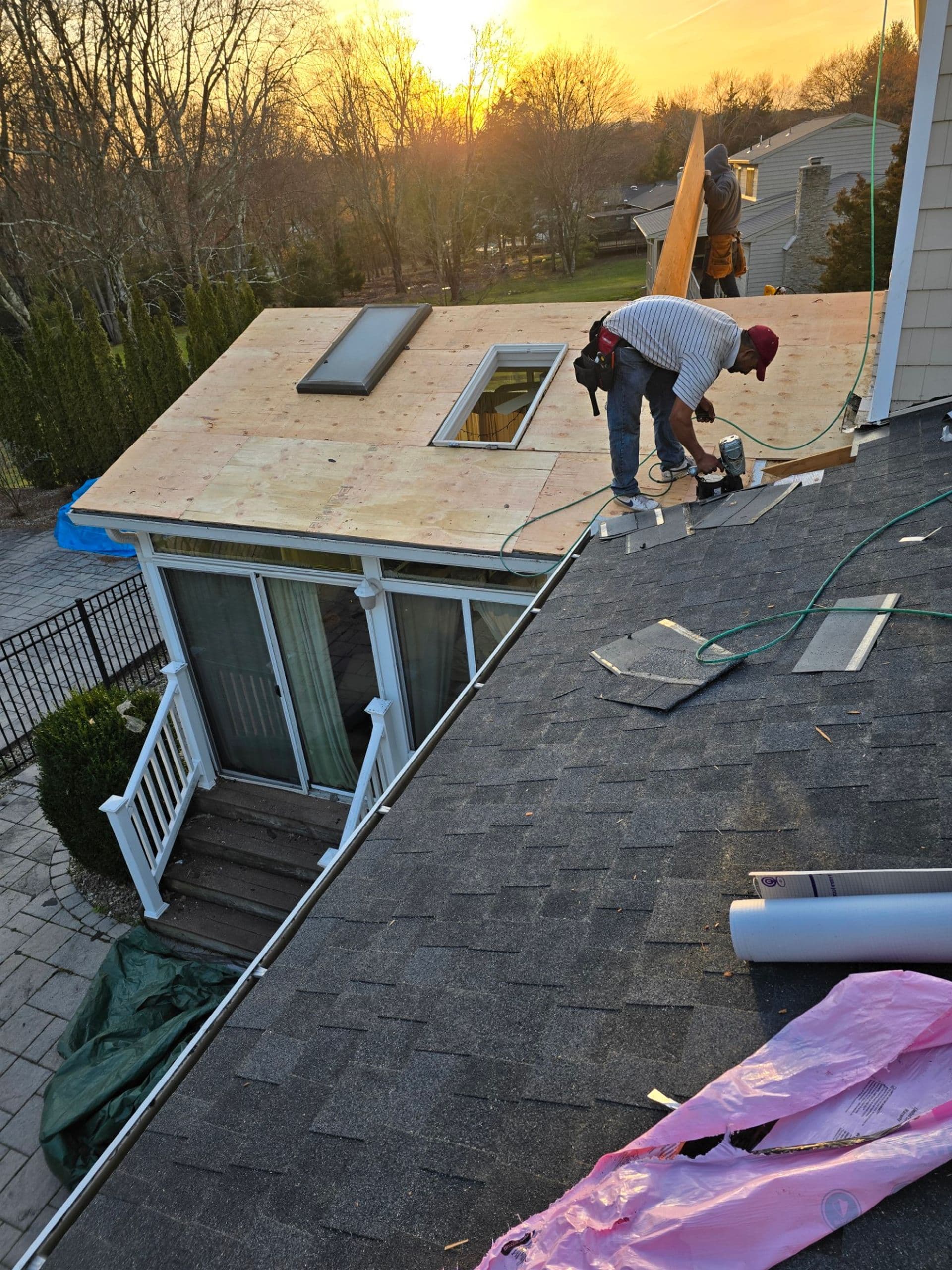 Bird's eye view of shingles getting installed on a roof